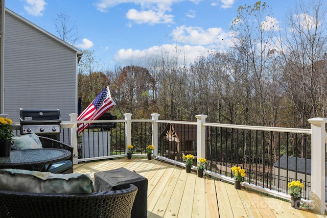 wooden terrace featuring a grill