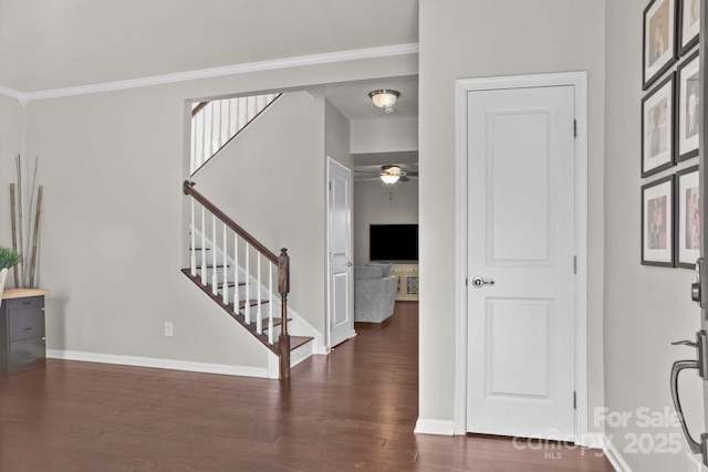 entryway with stairway, wood finished floors, and baseboards