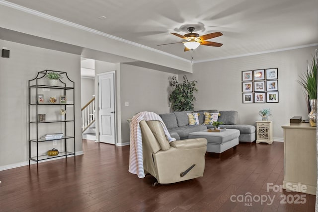 living room featuring stairs, dark wood-type flooring, a ceiling fan, and crown molding