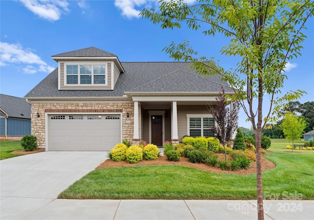 view of front of house with a front lawn and a garage