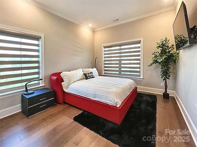 bedroom featuring hardwood / wood-style flooring and crown molding