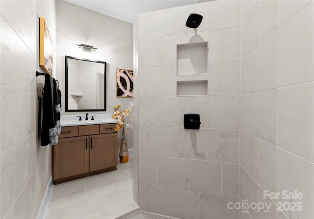 bathroom featuring vanity and a tile shower