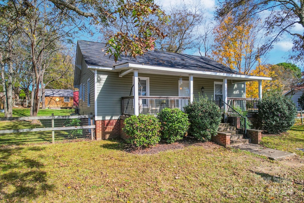 bungalow-style house with a porch and a front yard