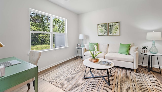 living area with wood finished floors and baseboards