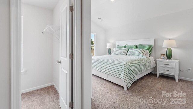 bedroom featuring carpet flooring, vaulted ceiling, visible vents, and baseboards