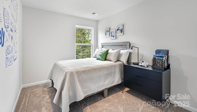 carpeted bedroom with visible vents and baseboards