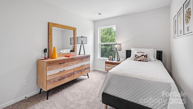 bedroom featuring light carpet, baseboards, and visible vents