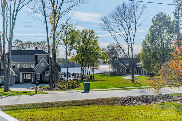 view of property's community with a yard and a water view