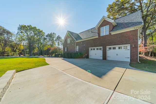 view of home's exterior featuring a lawn and a garage