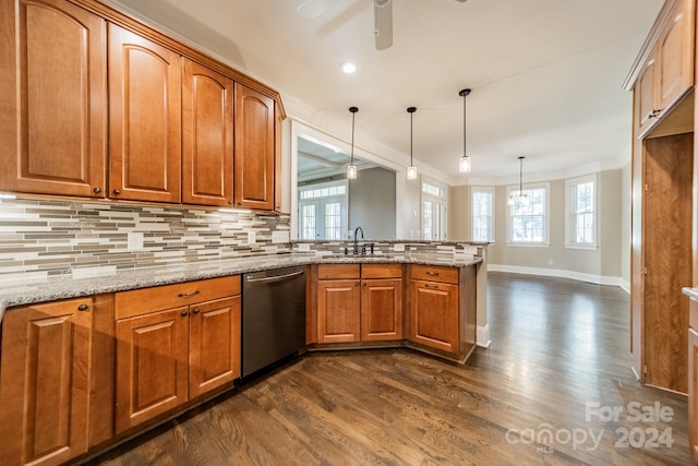 kitchen with stainless steel dishwasher, plenty of natural light, dark wood-type flooring, and hanging light fixtures