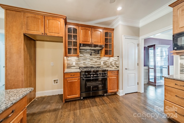 kitchen with light stone countertops, crown molding, high end range, and dark wood-type flooring