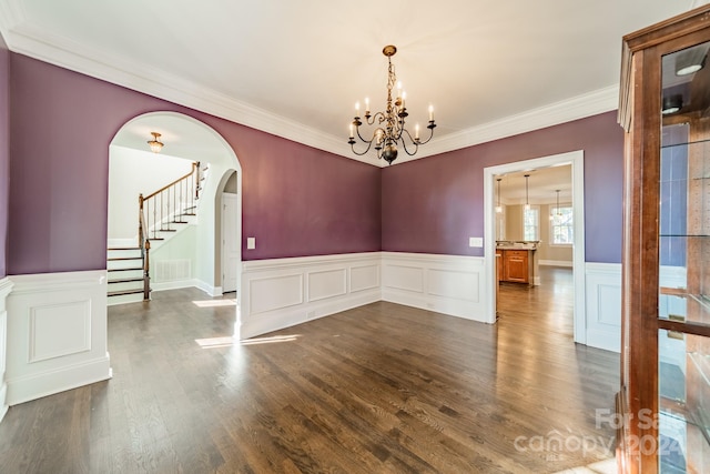 unfurnished room featuring crown molding, dark hardwood / wood-style flooring, and a chandelier