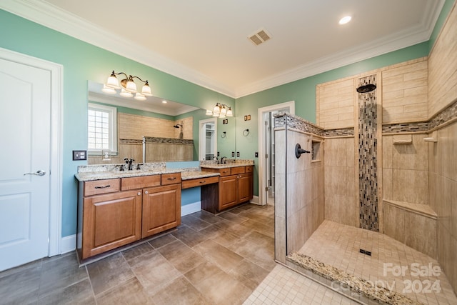 bathroom featuring vanity, a tile shower, and ornamental molding