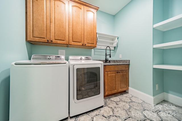 laundry room with cabinets, independent washer and dryer, sink, and light tile patterned floors