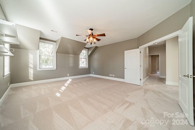 interior space featuring light carpet and ceiling fan