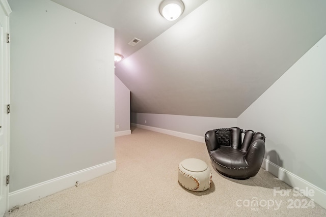 living area with carpet and lofted ceiling