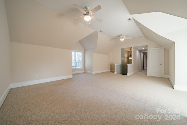 bonus room with ceiling fan, light carpet, and vaulted ceiling