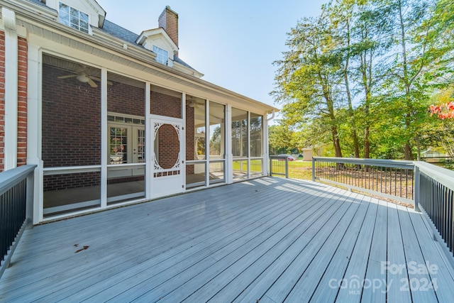 wooden deck with a sunroom