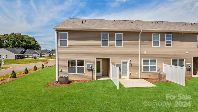 back of property with a yard and a patio area