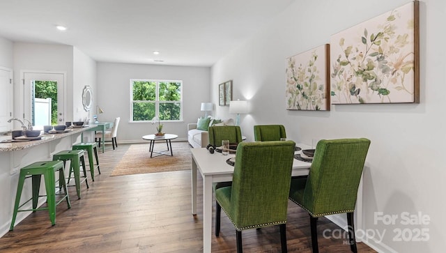 dining space featuring recessed lighting, wood finished floors, and baseboards