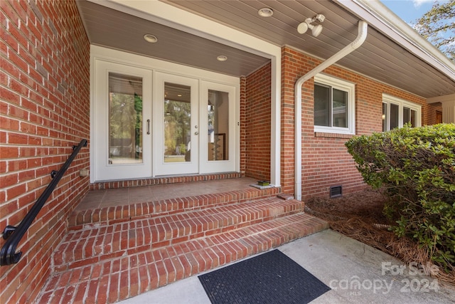 doorway to property with covered porch and french doors