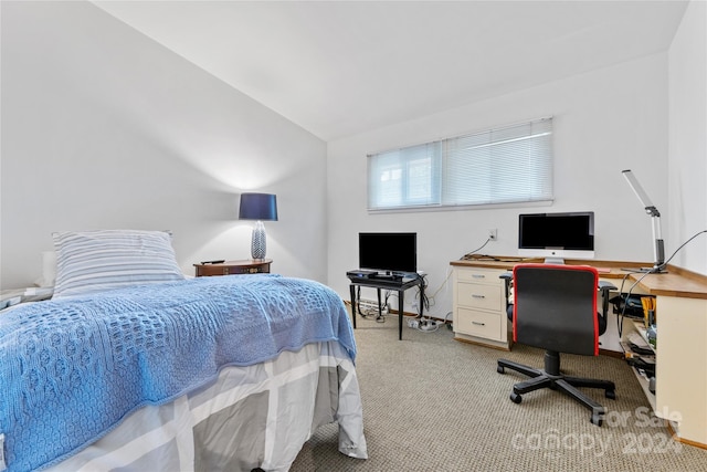 carpeted bedroom featuring lofted ceiling