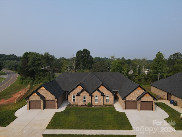 view of front of property featuring a garage and a front lawn