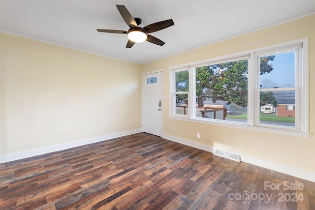 spare room featuring ceiling fan, dark hardwood / wood-style flooring, and ornamental molding