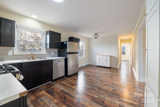 kitchen featuring tasteful backsplash, sink, dark wood-type flooring, and appliances with stainless steel finishes