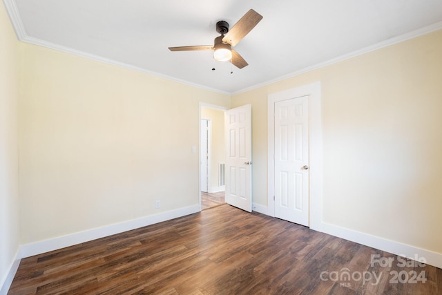 unfurnished bedroom with ceiling fan, ornamental molding, and dark wood-type flooring