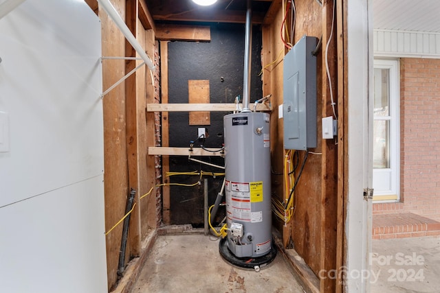 utility room with electric panel and water heater