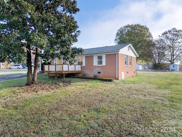 exterior space with a lawn and a wooden deck