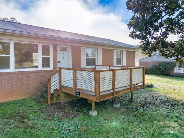 back of property featuring a deck