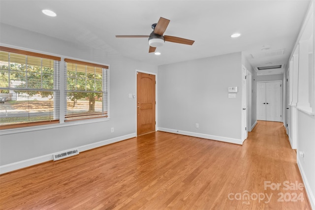 empty room featuring ceiling fan and light hardwood / wood-style flooring