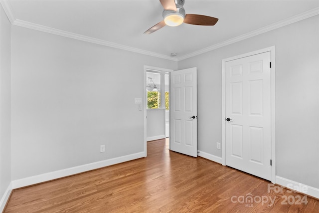 unfurnished bedroom with hardwood / wood-style floors, ceiling fan, and crown molding