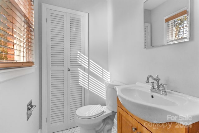 bathroom featuring tile patterned flooring, vanity, and toilet