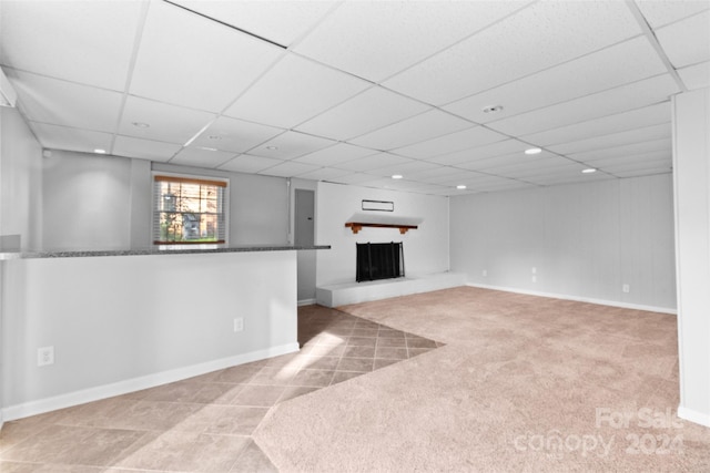 1532 Starbrook Dr, Charlotte, NC 28210 - below grade area with a paneled ceiling, recessed lighting, a fireplace with raised hearth, tile patterned flooring, and baseboards