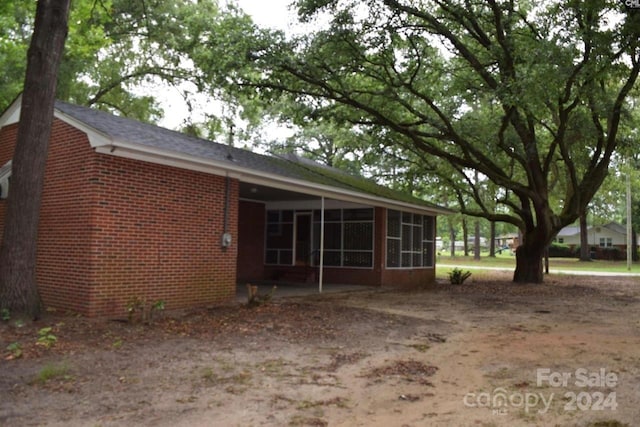 back of house featuring a sunroom