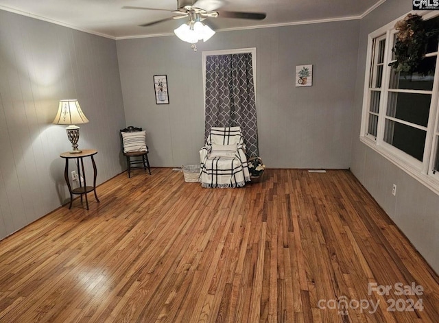 unfurnished room featuring hardwood / wood-style floors, ceiling fan, and ornamental molding