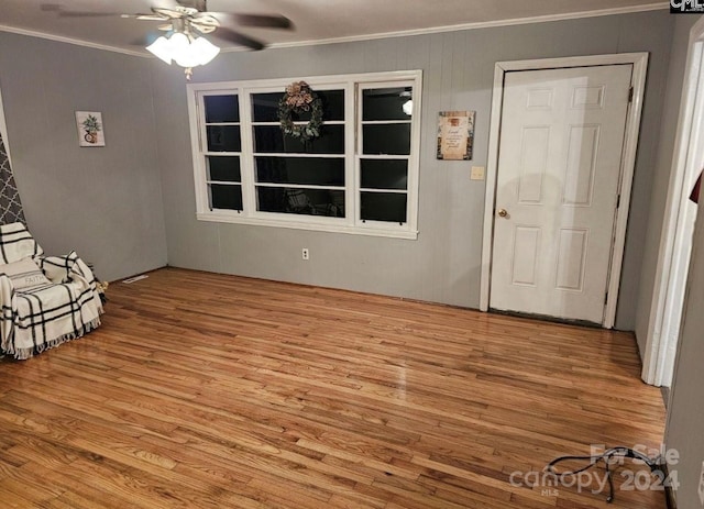 interior space featuring crown molding, light hardwood / wood-style flooring, and ceiling fan