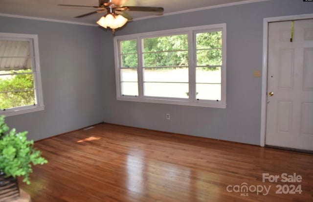 interior space featuring hardwood / wood-style floors, ceiling fan, and crown molding