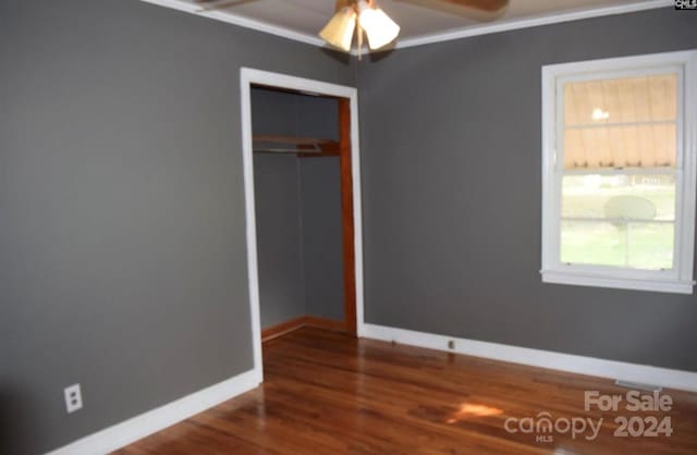 unfurnished bedroom featuring hardwood / wood-style flooring, ceiling fan, and a closet