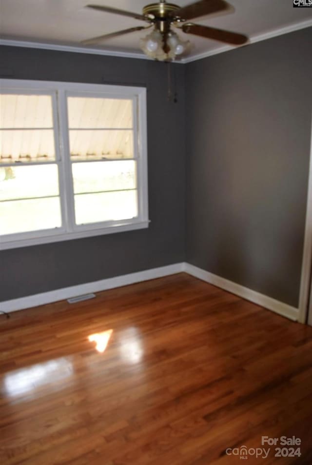 spare room featuring ceiling fan, ornamental molding, and hardwood / wood-style flooring