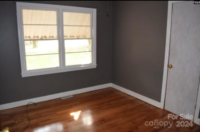 unfurnished room with wood-type flooring