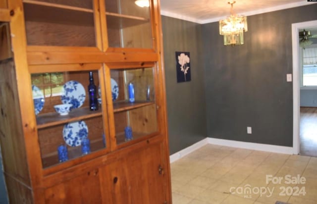 dining room featuring ornamental molding and a notable chandelier