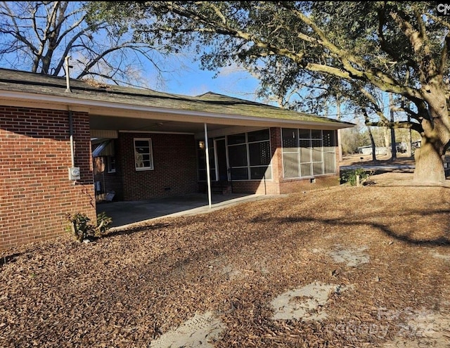 rear view of house featuring a sunroom