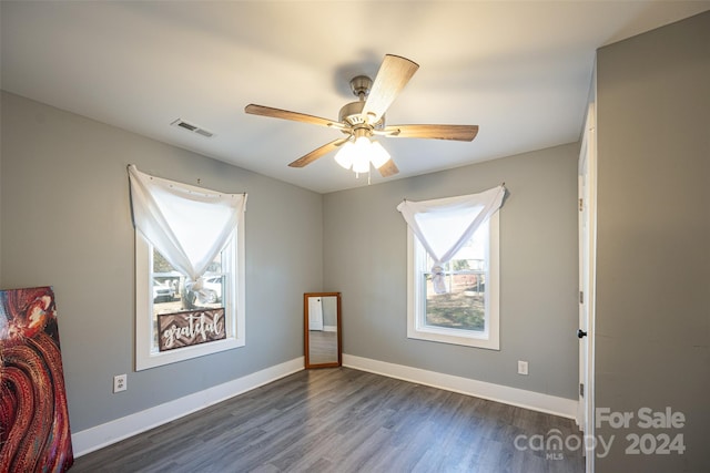 unfurnished room with ceiling fan and dark hardwood / wood-style flooring