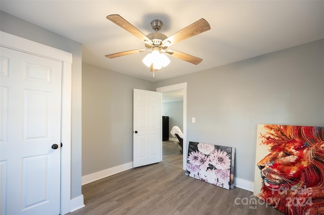 interior space with dark hardwood / wood-style floors and ceiling fan