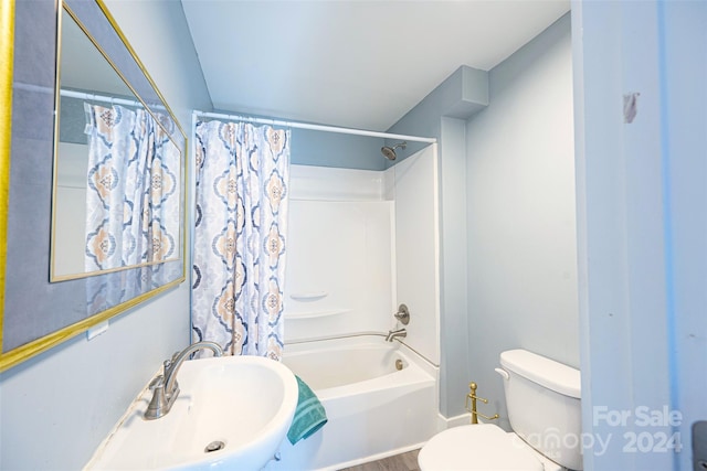 full bathroom featuring shower / bath combo, toilet, and sink