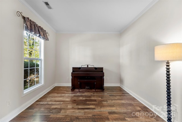 unfurnished room with ornamental molding and dark wood-type flooring